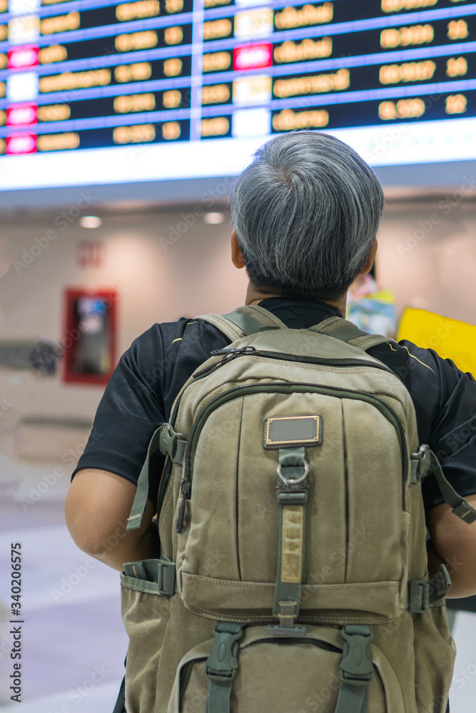 Traveler was cancel flights for stop prevent COVID-19 virus disease concept, Senior smart woman traveling luggage standing look flight schedule at airport terminal, Avoid world pandemic Corona virus Traveler was cancel flights for stop prevent COVID-19 virus disease concept, Senior smart woman traveling luggage standing look flight schedule at airport terminal, Avoid world pandemic Corona virus