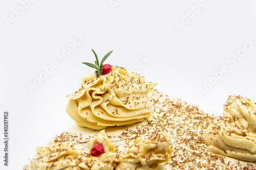 Homemade cake with flower background. Sweet dessert made at home with toffee cream. Sweet cake made from a mixture of flour, toffee, eggs, sugar, other ingredients, baked and decorated chocolate chips