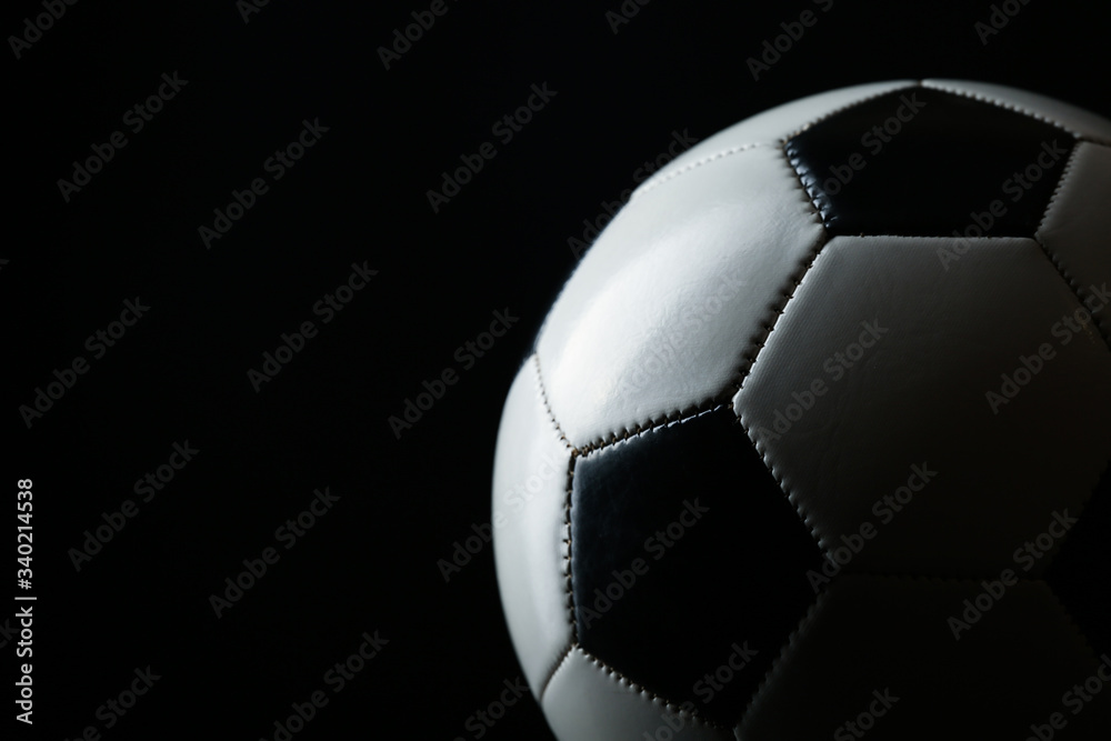 Fototapeta premium classic soccer ball with shadow on black background with copy space