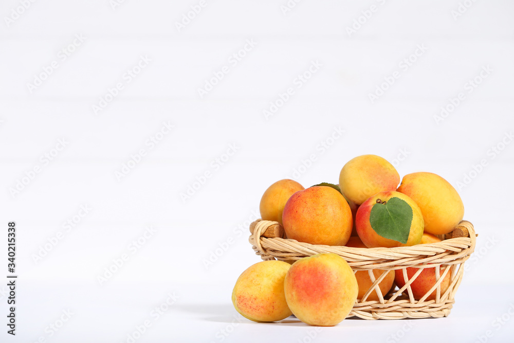 Sweet apricots in basket on white background Sweet apricots in basket on white background