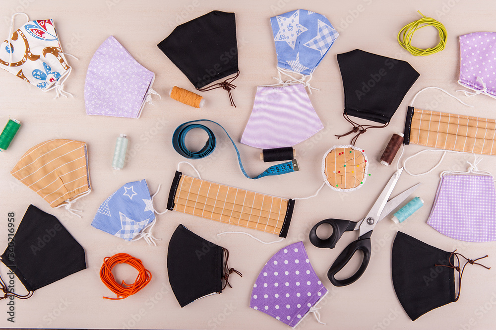 Protective exclusive medical face masks and and sewing supplies lie on the table Protective exclusive medical face masks and and sewing supplies lie on the table