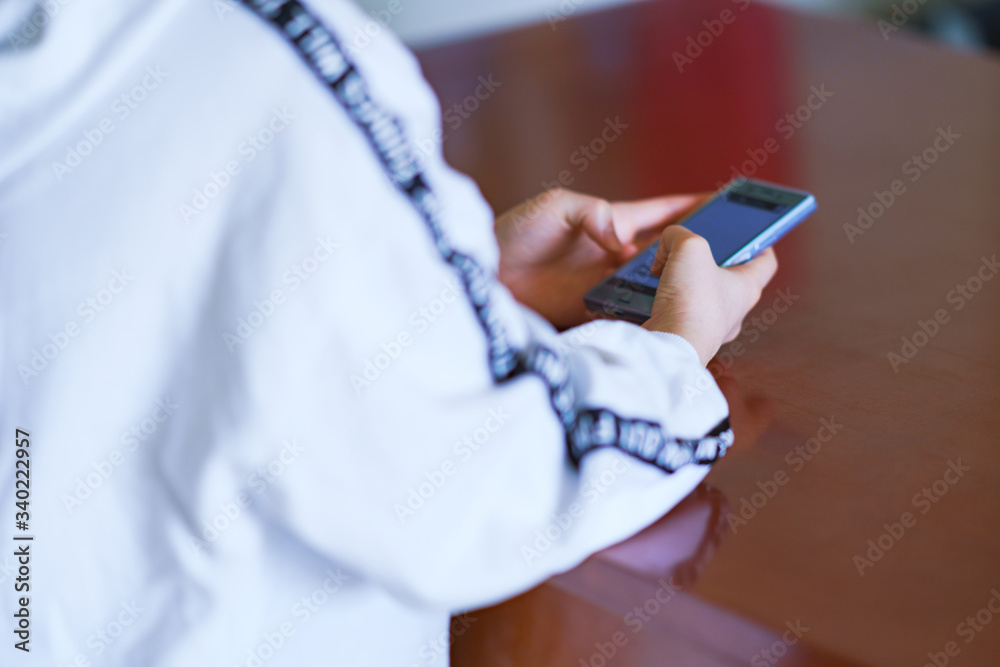 Fototapeta premium Japanese girl looking smart phone at home