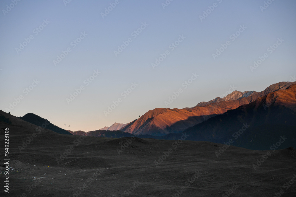 Naklejka premium Mountains are lit by the setting sun in the Tusheti region.