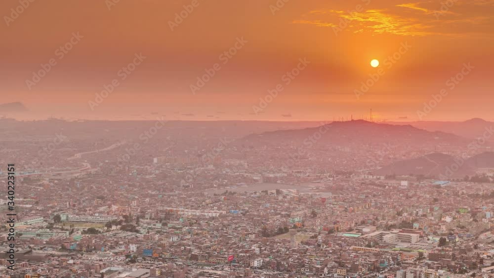 Aerial sunset view of Lima skyline timelapse from San Cristobal hill. Traffic on bridges and Rimac river. Landscape of slum urban area and historic buildings in South America. Orange sky. Peru Aerial sunset view of Lima skyline timelapse from San Cristobal hill. Traffic on bridges and Rimac river. Landscape of slum urban area and historic buildings in South America. Orange sky. Peru