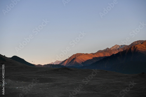 Mountains are lit by the setting sun in the Tusheti region.