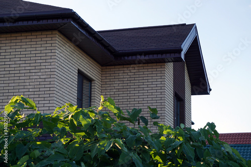 modern new brick house with flexible tiles