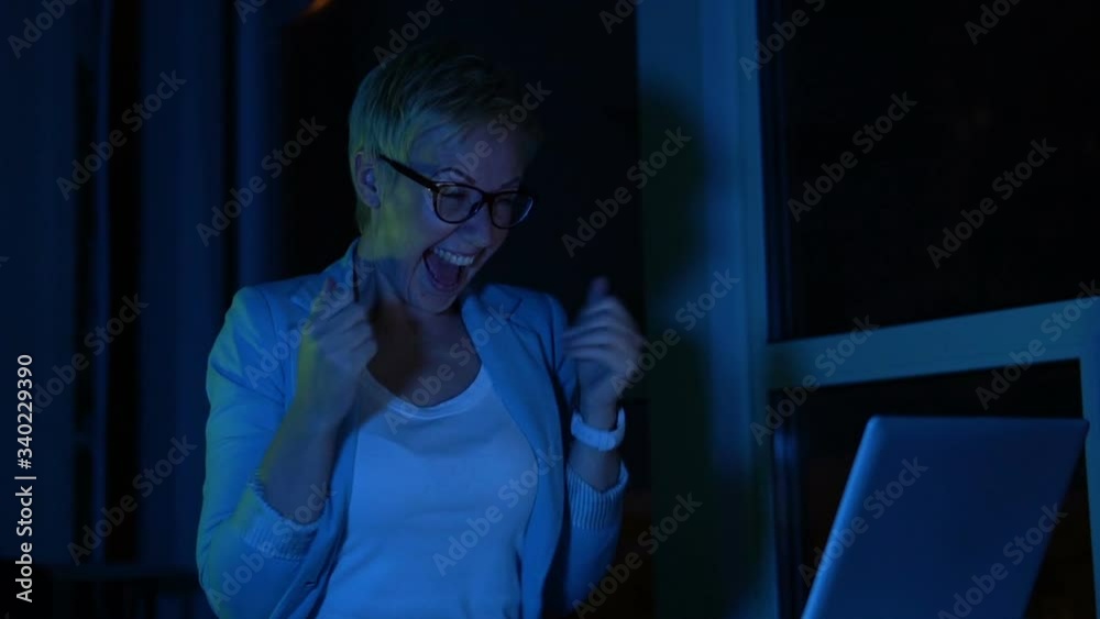 Very excited woman screaming and applauding reading message about lottery win