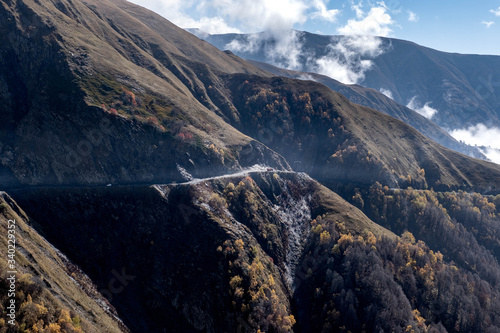 A truck follows a dangerous road down the mountain from Omalo to Alvani in Georgia photo