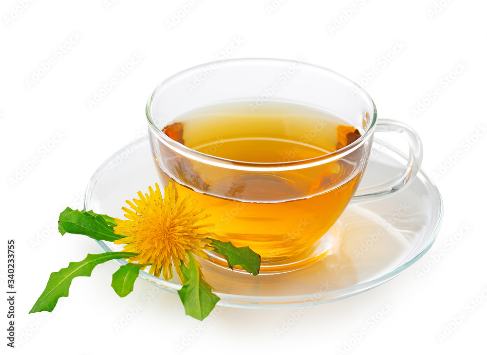 Dandelion tea in a transparent cup with dandelion flower and leaves Dandelion tea in a transparent cup with dandelion flower and leaves
