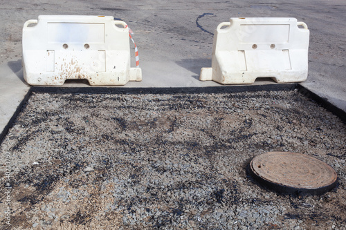 The sewer hatch and pit next to it. Asphalt repair photo