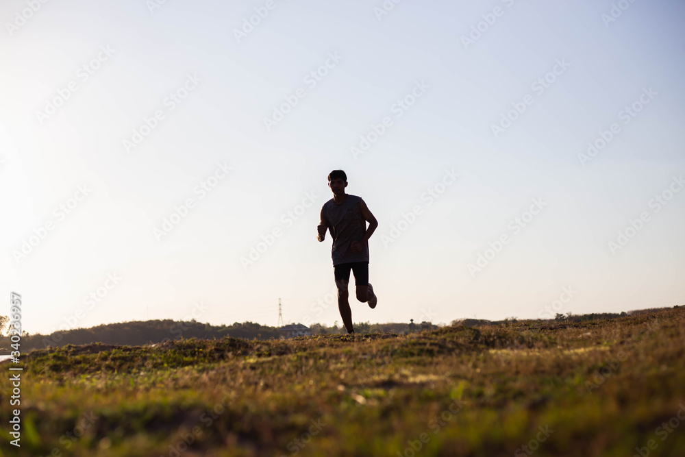 The man with runner on the street be running for exercise.