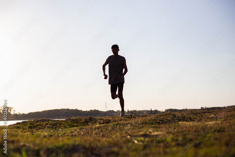 The man with runner on the street be running for exercise. The man with runner on the street be running for exercise.