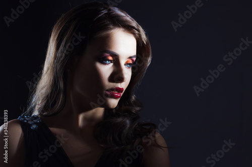 luxurious and mysterious beauty in Noir style, a portrait on a black background,