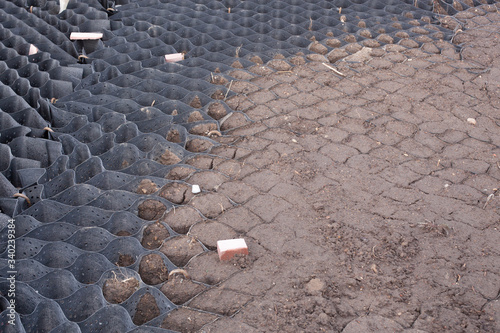 Polymer geogrid halfway filled with soil photo