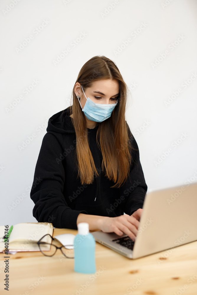 Young business woman working from home wearing medical protective mask, coronavirus quarantine Young business woman working from home wearing medical protective mask, coronavirus quarantine