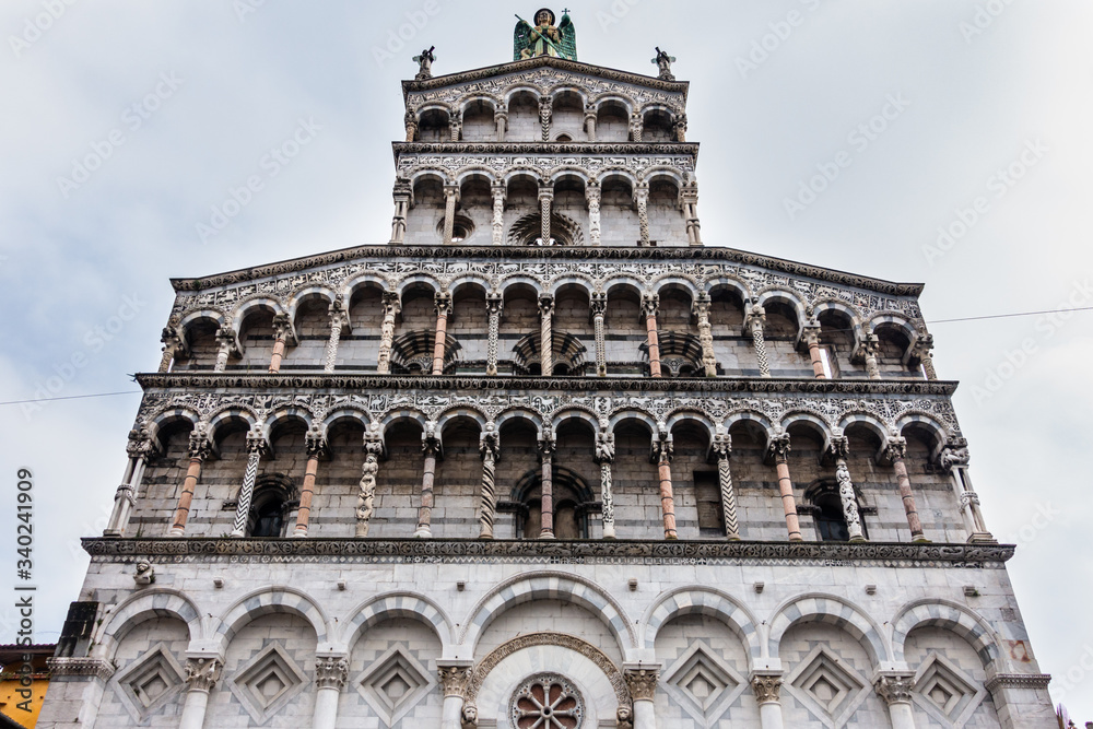 Facade of the church  San Michele in Foro in Lucca, finely decorated with statues and sculptures, Tuscany, Italy