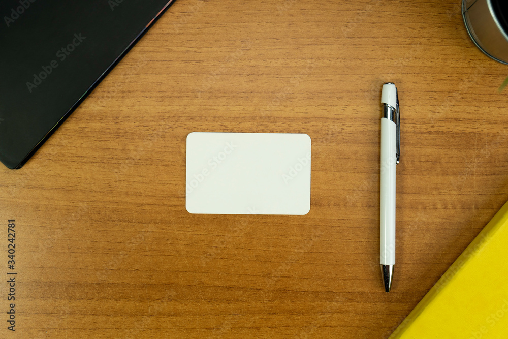 Stationery set with various objects around a white business card with round corners and white pen for mockup purposes Stationery set with various objects around a white business card with round corners and white pen for mockup purposes