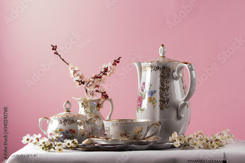 Antique tea set on a pink background
