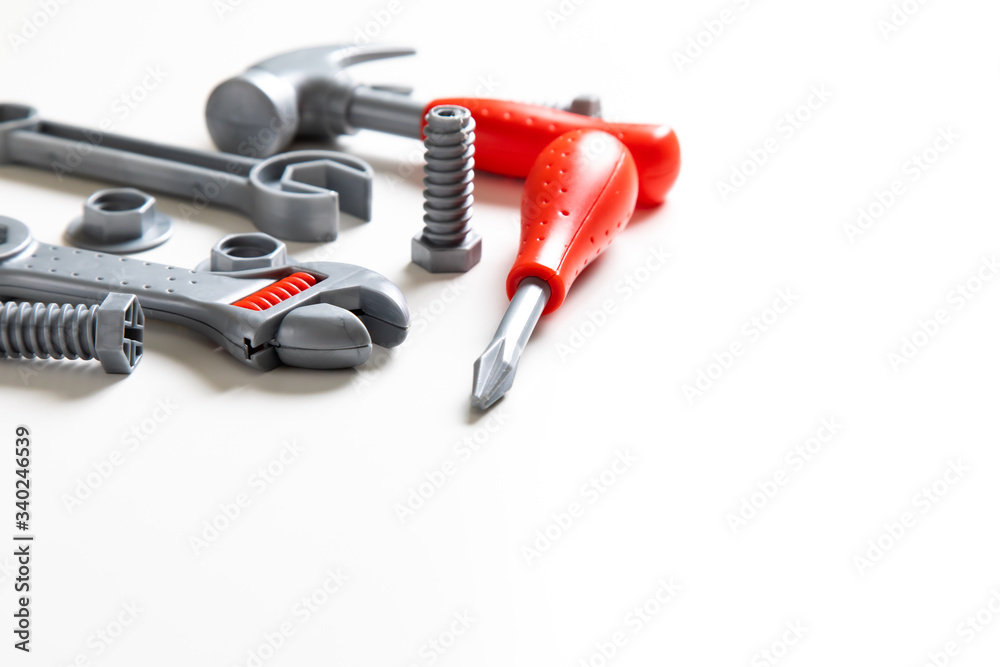 Top view. Plastic mechanic children Tool flat lay background. Space for text design. Mechanic Tools toy on white background Top view. Plastic mechanic children Tool flat lay background. Space for text design. Mechanic Tools toy on white background