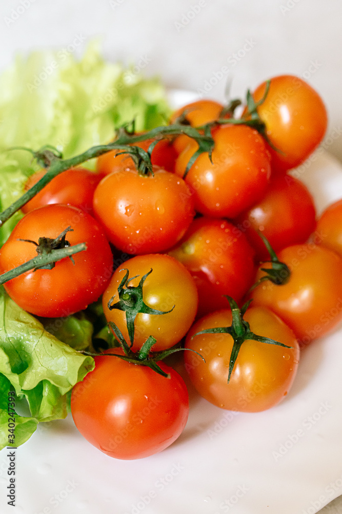 Cherry tomatoes with lettuce on a gray background
Cherry tomatoes with lettuce on a gray background