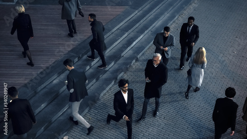 High Angle Shot of Office Managers and Business People Commuting to Work in the Morning or from Office in the Evening on Foot. Pedestrians are Dressed Smartly. Successful People Holding Smartphones.