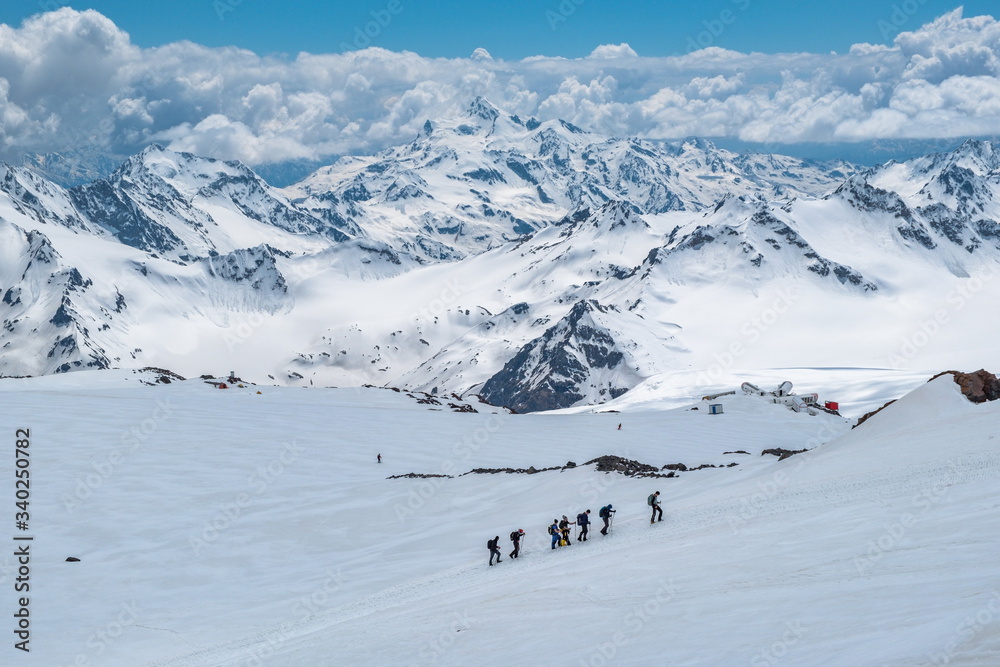 Caucasian mountains. A group of climbers climbs the mountain.