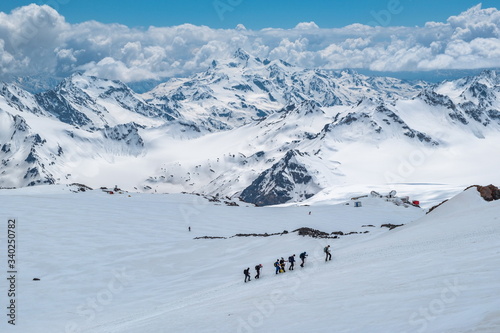 Caucasian mountains. A group of climbers climbs the mountain.
