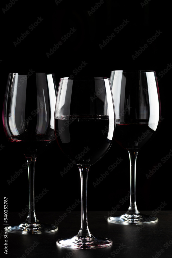 Red wine glasses on black background Red wine glasses on black background
