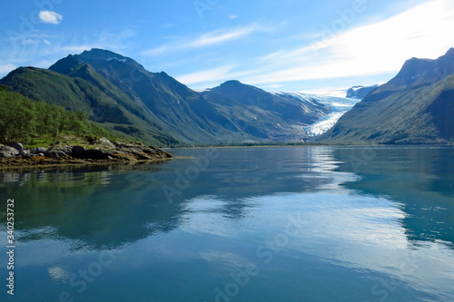 View of the beautiful mountain landscape reflecting in the Holandfjord near Svartisenvasnet - Svartisen Lake in front of the Engabreen glacier  Norway  Europe 