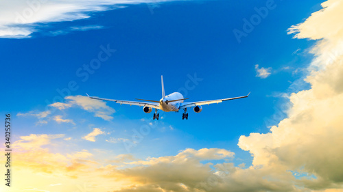 Commercial airplane flying in beautiful sky at sunset travel concept.