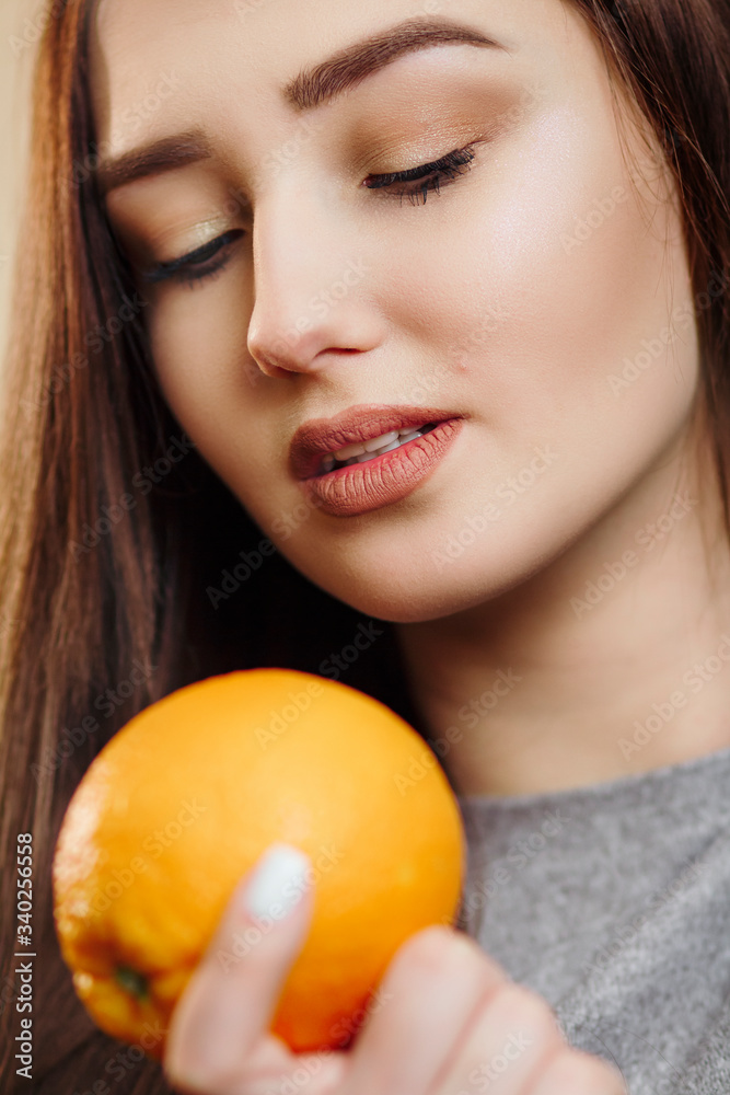 bright picture of beautiful woman with orange halves, girl face with languid look, fashion model, concept fruits and healthy food bright picture of beautiful woman with orange halves, girl face with languid look, fashion model, concept fruits and healthy food