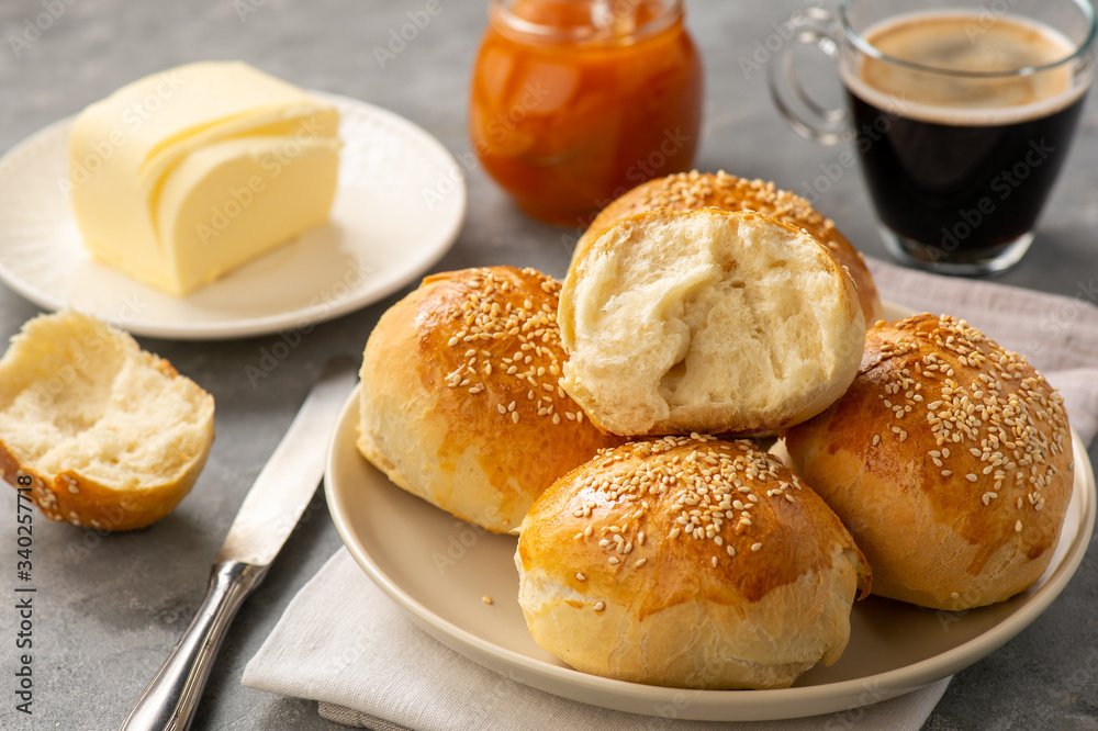 Homemade fresh buns served with butter and apricot jam. Homemade fresh buns served with butter and apricot jam.