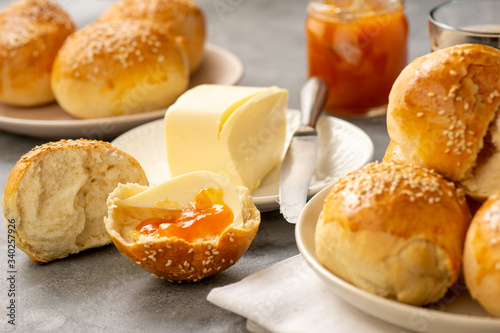 Homemade fresh buns served with butter and apricot jam.
