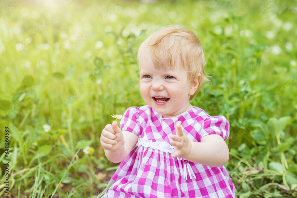 Little child girl sitting in a flowers meadow. Seasonal allergy concept Little child girl sitting in a flowers meadow. Seasonal allergy concept