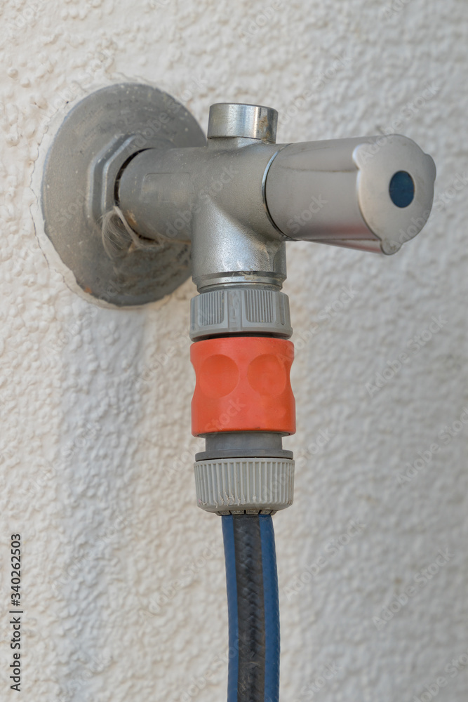 water tap on a wall of a house