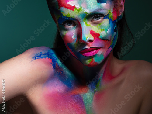 Multicolored skin, difficult to identify. Creative makeup and drawing on the face. photo