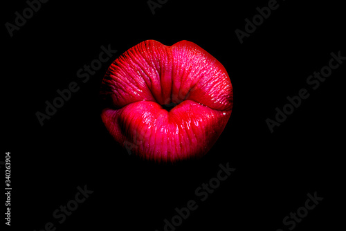 Lips kiss isolated on black. Close up of womans pouting lips with red lipstick. Beautiful red lip. Love and kissing gesture. Plump sexy full lips.
