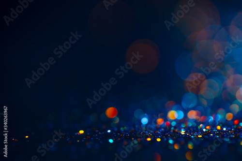 Fototapeta Naklejka Na Ścianę i Meble -  Festive twinkle glitters background, abstract sparkle backdrop with circles,modern design overlay with sparkling glimmers. Black, blue and golden backdrop glittering sparks with glow effect