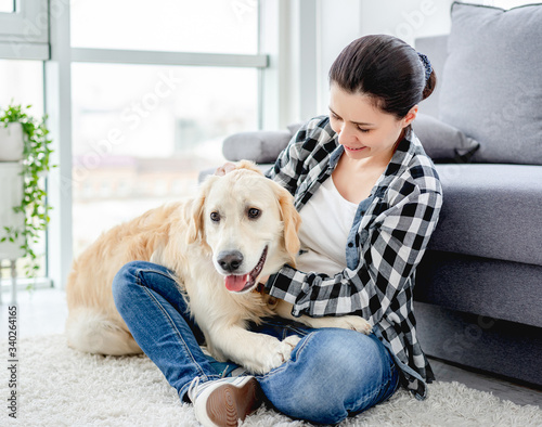 Pretty woman cuddling cute dog