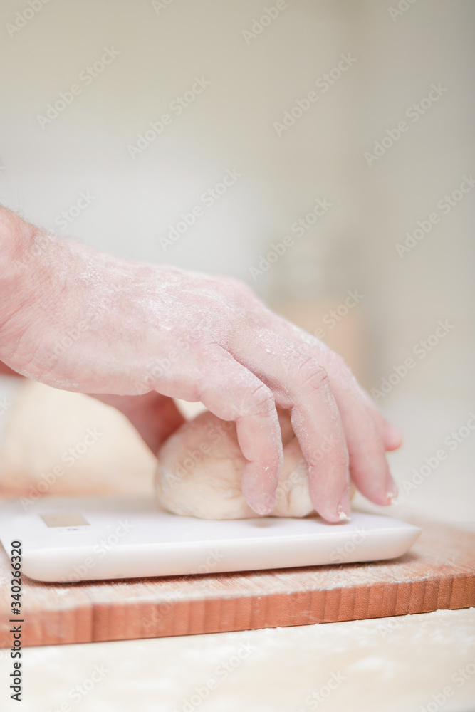 man's hand making pizza dough