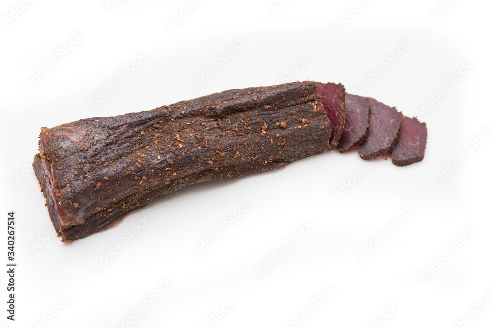 Beef Biltong, South African Beef Jerky isolated on a white studio background. Beef Biltong, South African Beef Jerky isolated on a white studio background.