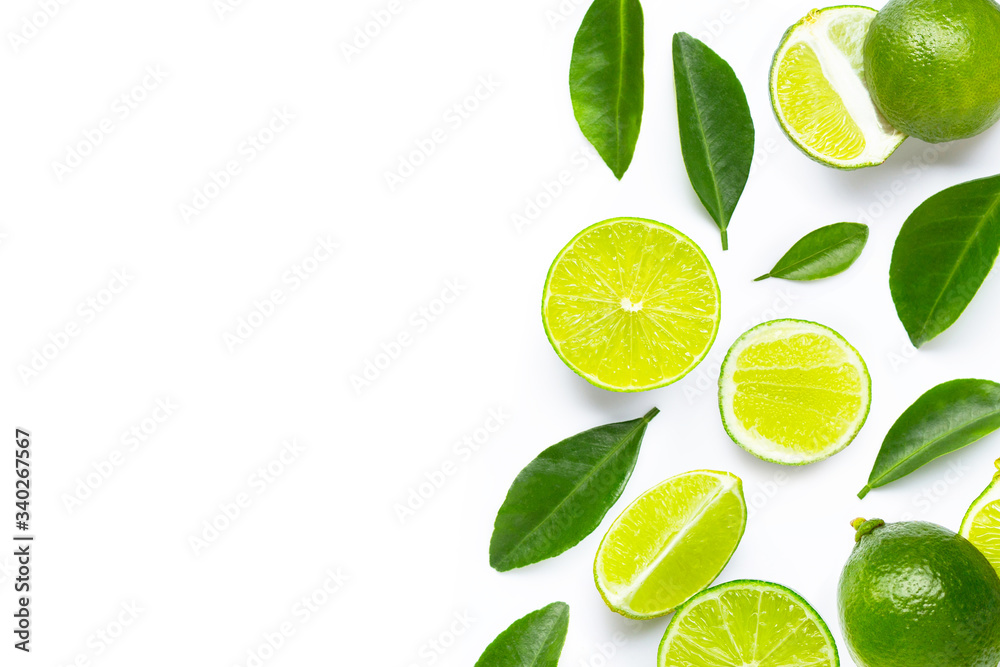 Fresh limes and leaves on white background.