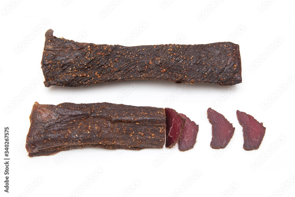 Beef Biltong, South African Beef Jerky isolated on a white studio background. Beef Biltong, South African Beef Jerky isolated on a white studio background.