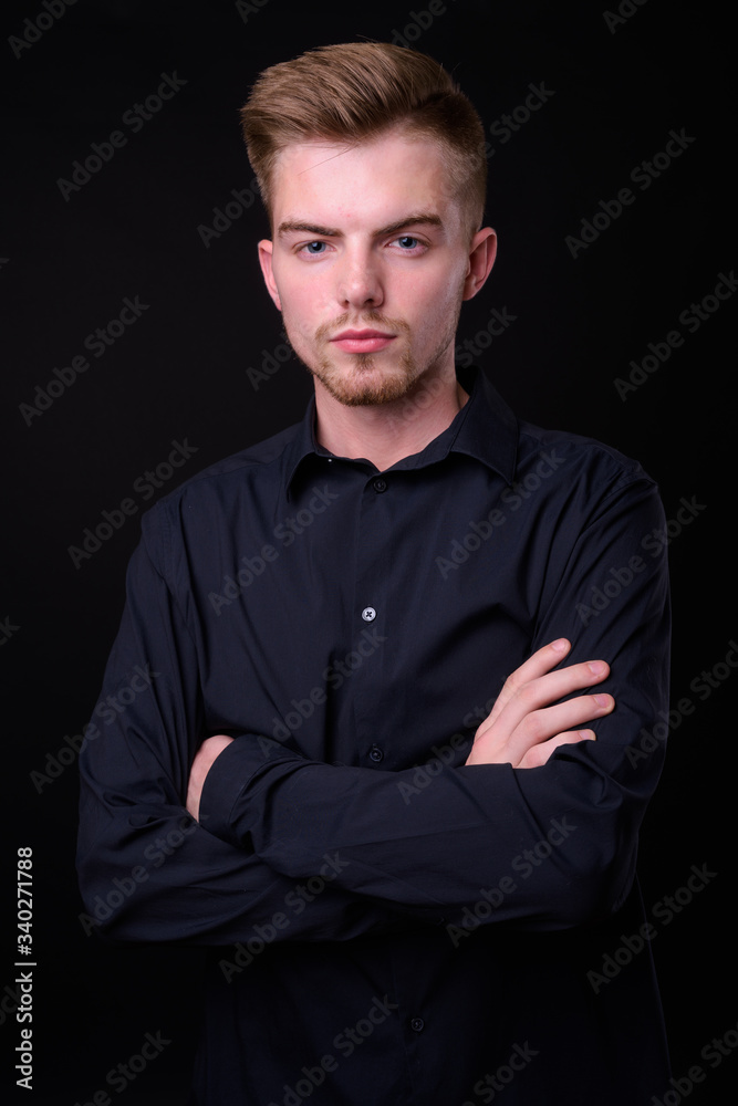 Portrait of young handsome blond bearded businessman