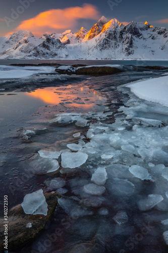 Soft tones of the golden hour in mountains at the coast of Vareid, Lofoten, Norway 