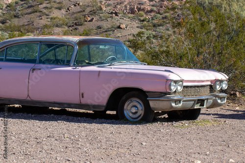 Vintage pink car abandoned in the desert