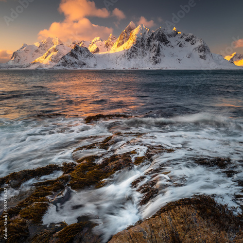 Soft tones of the golden hour in mountains at the coast of Vareid, Lofoten, Norway 