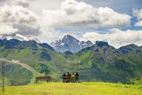 a family admires a picturesque view of the mountains in the summer