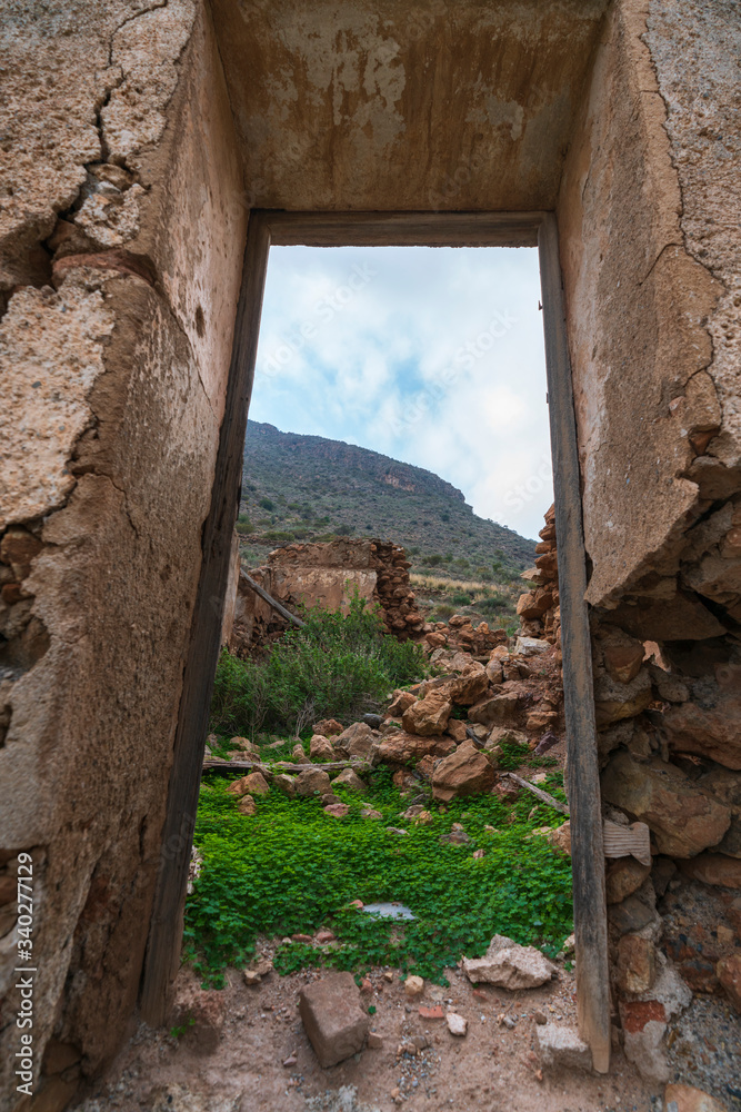 Fototapeta premium ruins of a farmhouse in Cejor next to the green river