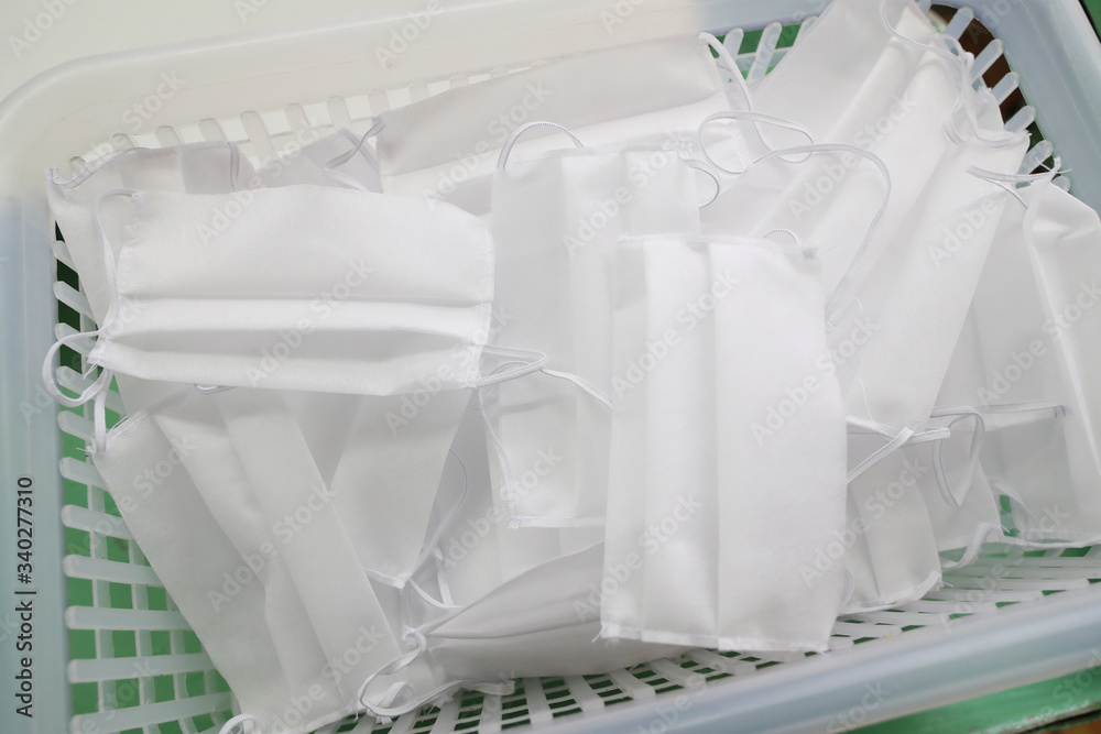 White medical masks are on the table. Tailoring of masks during epidemics White medical masks are on the table. Tailoring of masks during epidemics